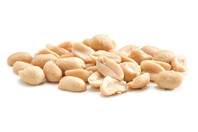 Close-up view roasted salted peanuts isolated on white background, arranged peeled peanuts