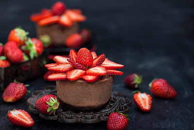 Mini chocolate cheesecake  dessert decorated with fresh strawberries