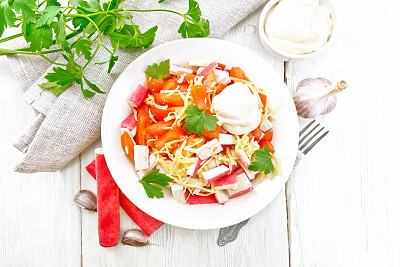 Salad of surimi and tomatoes on board top