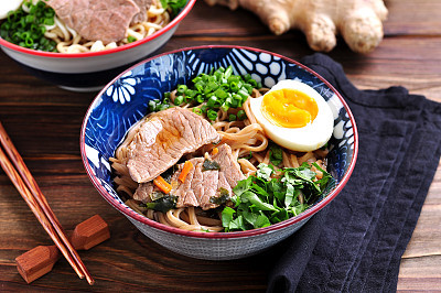 Soup with soba and ramen noodles, beef, ginger, green onions