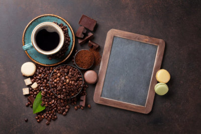 Coffee cup, beans and macaroons