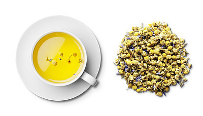 Cup of camomile and lavender tea and tea leaves overhead