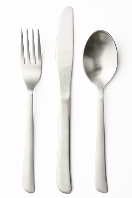 Table knife, spoon and fork on white background