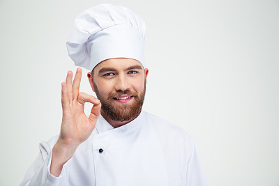 Smiling male chef cook showing ok sign