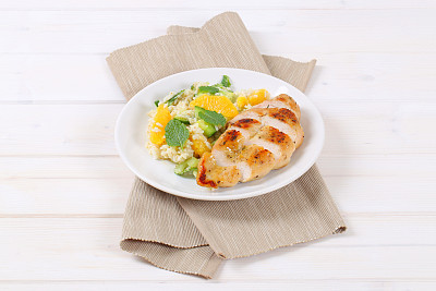 roasted chicken breast with rice and oranges