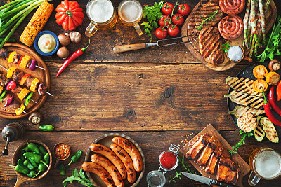 Grilled meat and vegetables on rustic wooden table