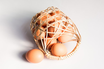 egg in basket wicker on white background,