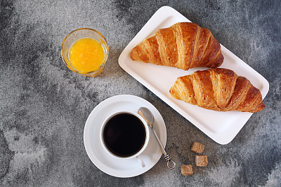 Two croissants, orange juice and coffee