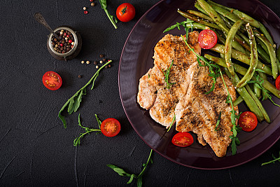 Turkey- chicken fillet cooked on a grill and garnish of green beans. Flat lay. Top view