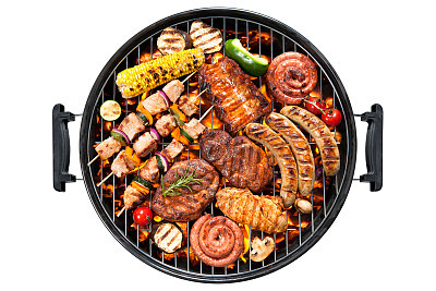 Overview of various meats and vegetables on a round grill