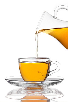 Pouring Tea into Glass Cup