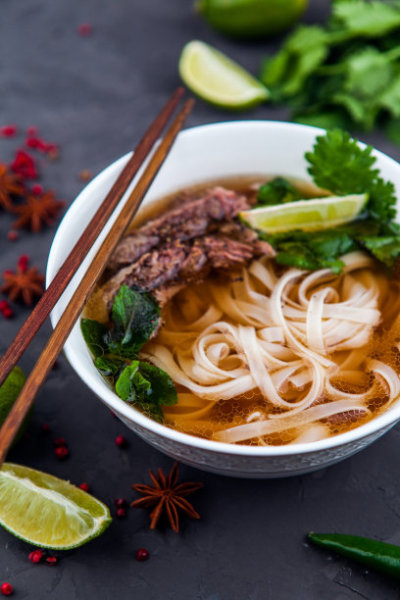 Vietnamese Beef Noodle Soup Pho Bo with beef on dark background
