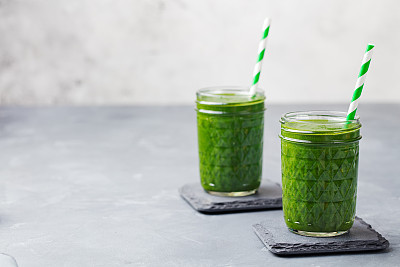 Spinach smoothie Healthy drink in glass jar. Copy space