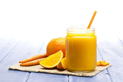 Glass jar with orange and carrot juice