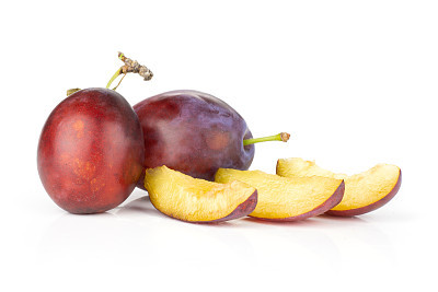 Fresh Raw vibrant plums isolated on white