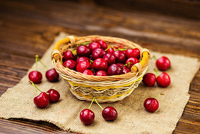 red cherries in basket, herry basket, red herries on wooden table with water drops macro background, red cherries on a brown background, basket with cherries