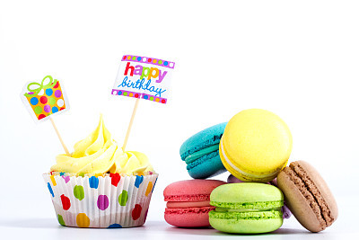 Collection of brightly colored French macarons on white background