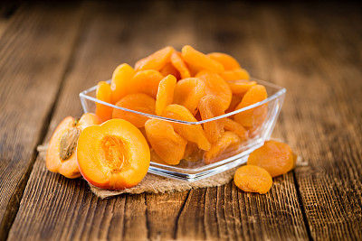 Dried Apricots (selective focus) on vintage wooden background