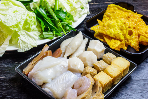 Shabu set ready to eat on wood table. Vegetables, dumpling, and shabu set.
