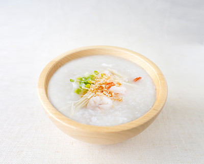 porridge rice with shrimp in wooden bowl. top view photo