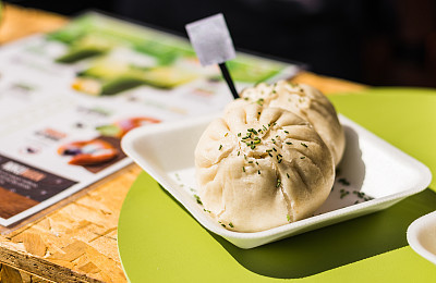 Asian Chinese steamed baozi buns with pork and spring onion at a street food market