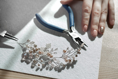 young woman makes jewelry