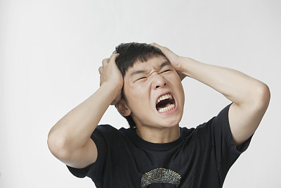 Shouting Chinese man studio portrait