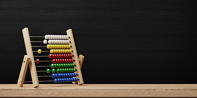 Abacus Standing In Front Of Blackboard