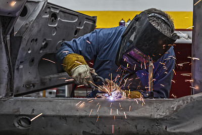 Welder Uses Torch on Car He is Welding
