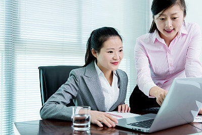 Two businesswomen working together