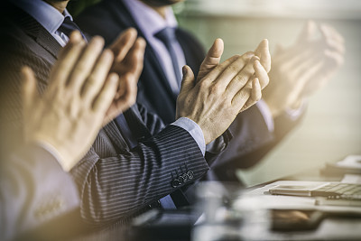 Close up of businessmen's hands clapping on a meeting