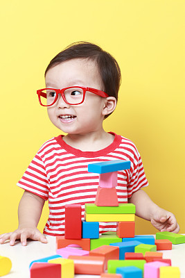 Cute Asian baby playing with blocks
