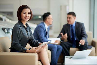 Female executive working in car salon