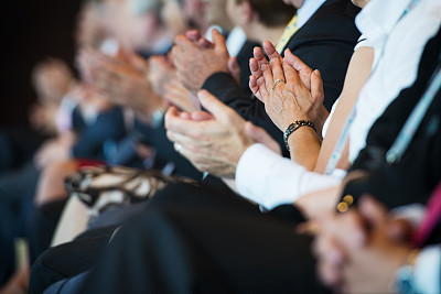 Applauding businesspeople in a row