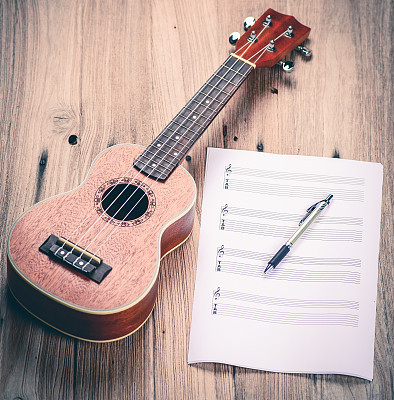 Ukulele and musical paper notes. vintage tone style