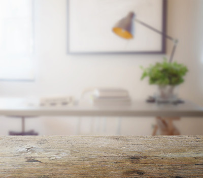wooden table top with blur of modern working table