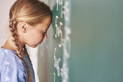 Schoolgirl trying to understand formula