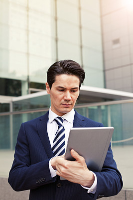 Japanese businessman using digital tablet, Tokyo.