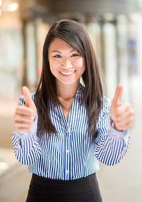 Asian business woman with thumbs up