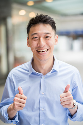Asian business man with thumbs up