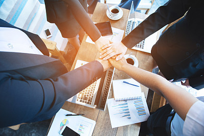 Close up of young asian business woman top view putting their hands together. Unity and teamwork concept,process in vintage style.