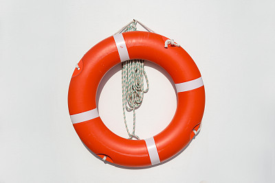 life belt hanging on white wall at the pool