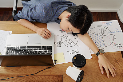 Businesswoman sleeping at her workplace