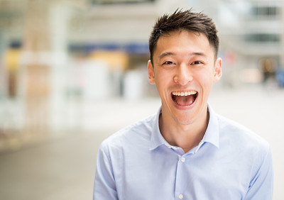 Happy business man screaming and looking thrilled