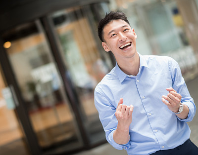 Successful Asian business man celebrating an achievement