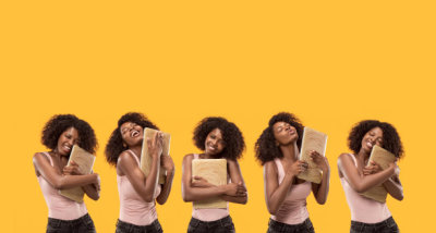 The happy businesswoman with laptop on orange