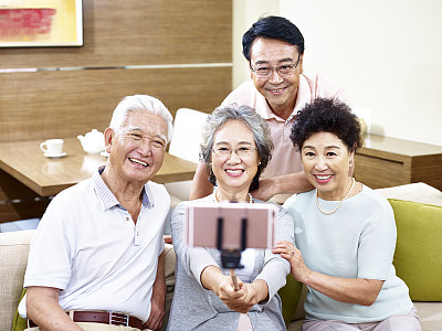 two senior asian couple taking a selfie together