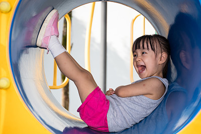 Asian Chinese little girl sitting in the tunnel