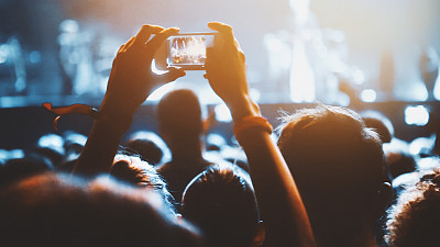 Taping a concert with smartphone.