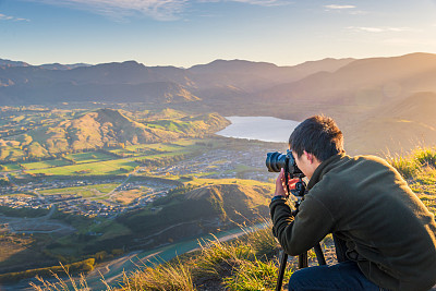 Young travler taking photo at queen town  in new zealand